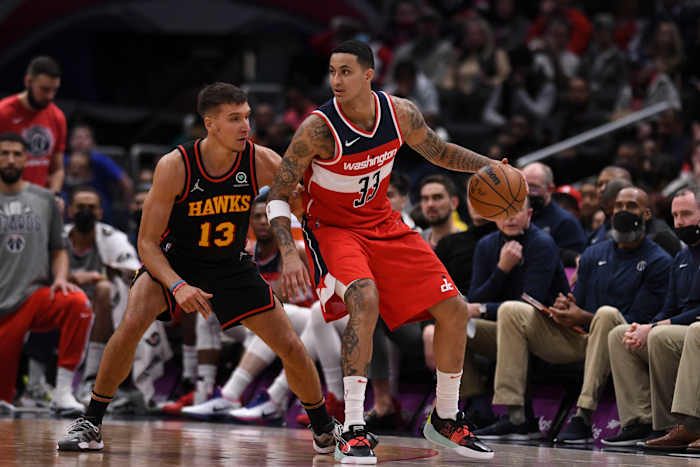 Wizards forward Kyle Kuzma dribbles into Hawks guard Bogdan Bogdanovic.